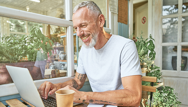 man sitting down to computer